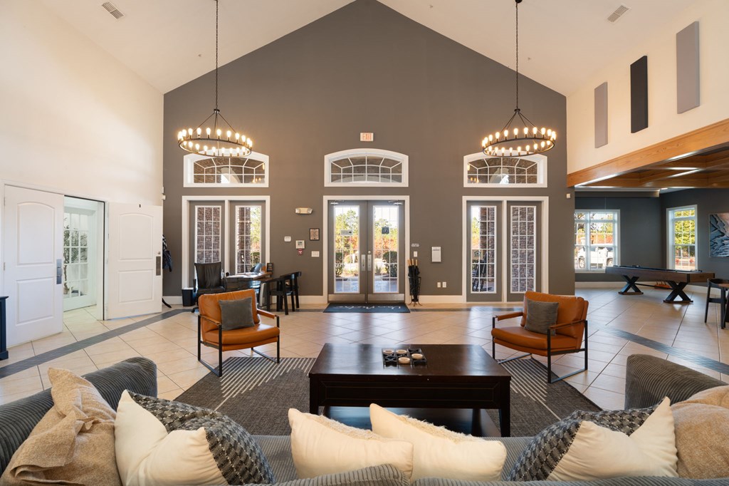 A large, open living room with a grey couch and a coffee table.