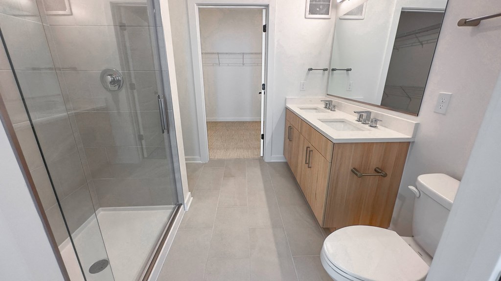 a small bathroom with a shower sink and toilet