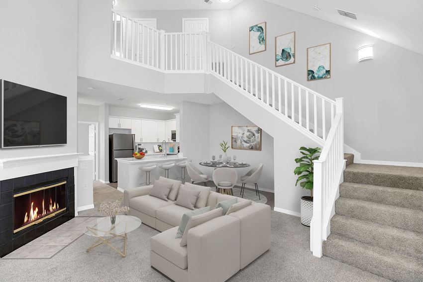 a living room with a staircase in the background and a couch in the foreground - Photo Gallery 1