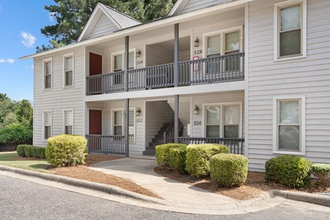 A two-story building with a balcony on the second floor.