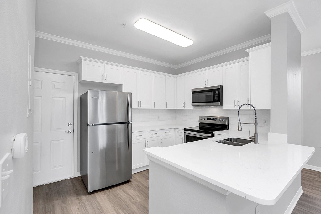 a kitchen with white cabinets and stainless steel appliances at Northlake Park, Florida,32827
