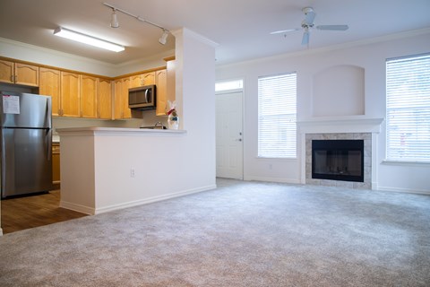 A kitchen with wooden cabinets and a stainless steel refrigerator.