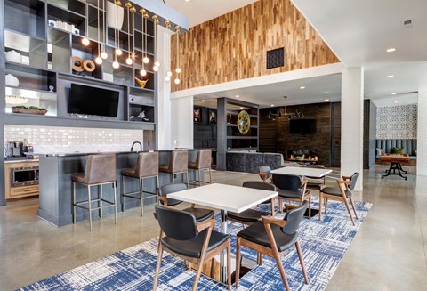 A modern kitchen with a dining area and a bar.
