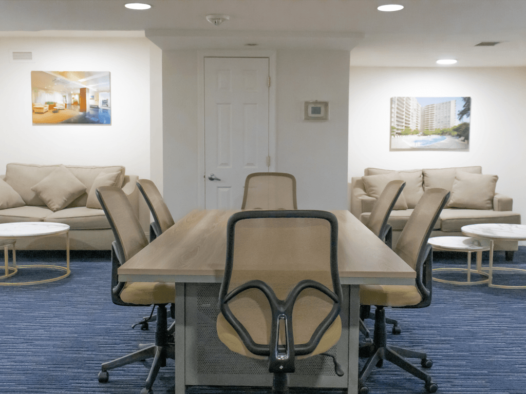 a conference room with a table and chairs and a couch at The Aspen, Virginia, 22305