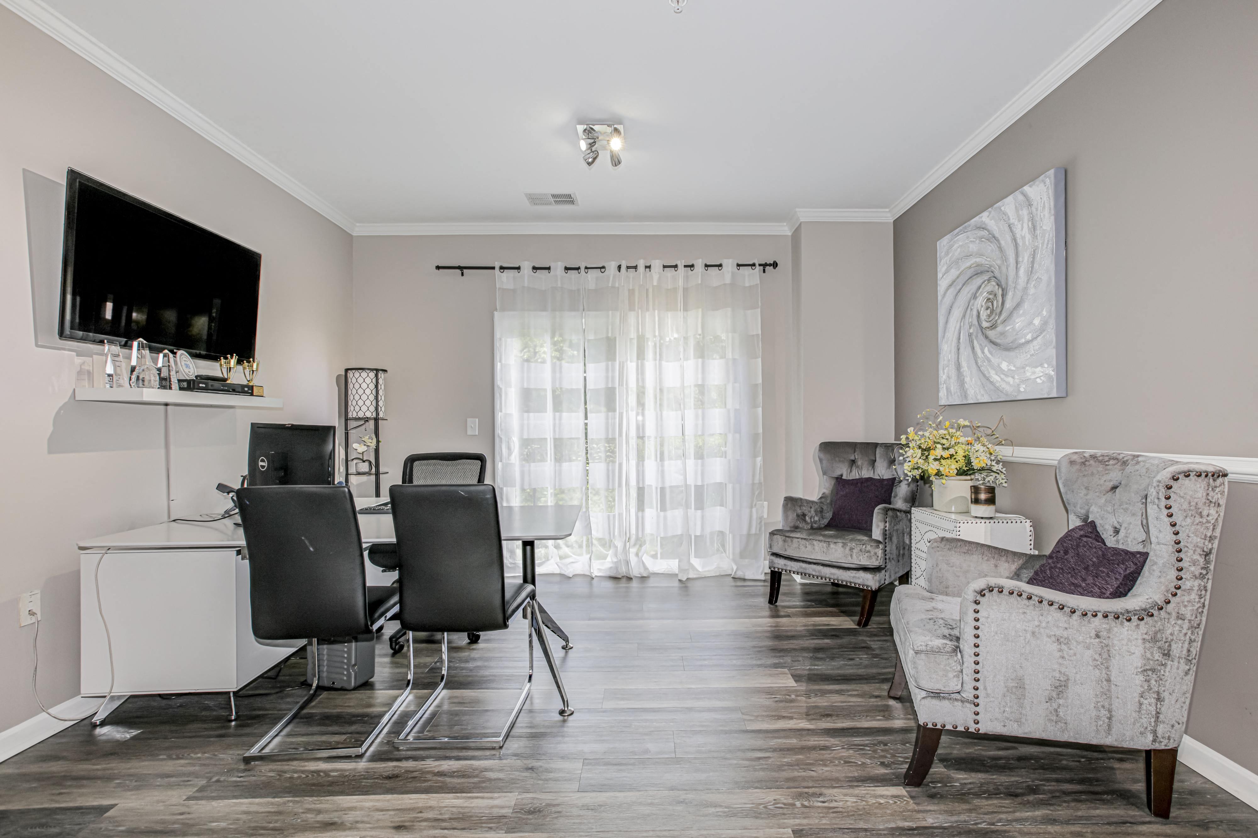 a living room and dining room with a table and chairs