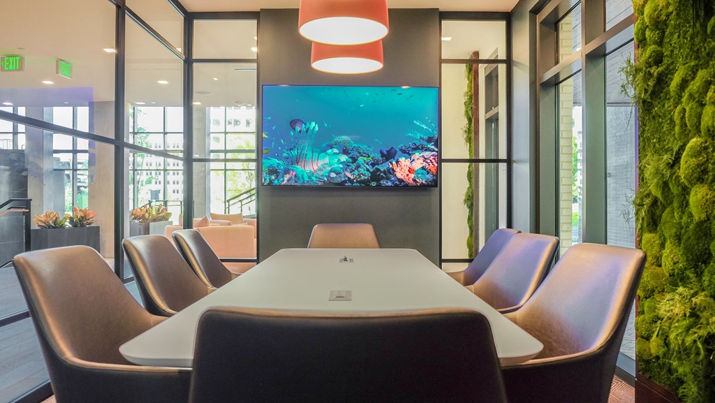 a conference room with a table and a fish tank at Makers Rise, Herndon, VA