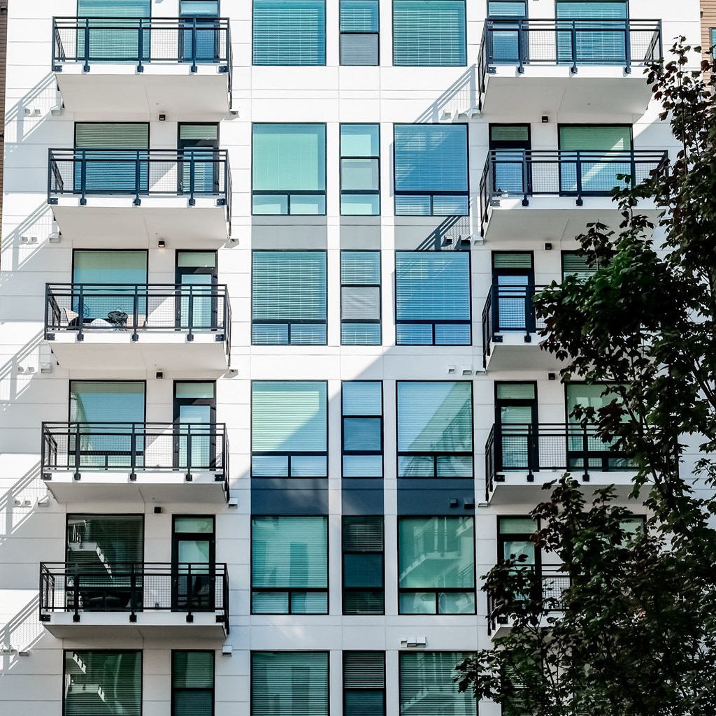 the facade of an apartment building with windows and balconies
