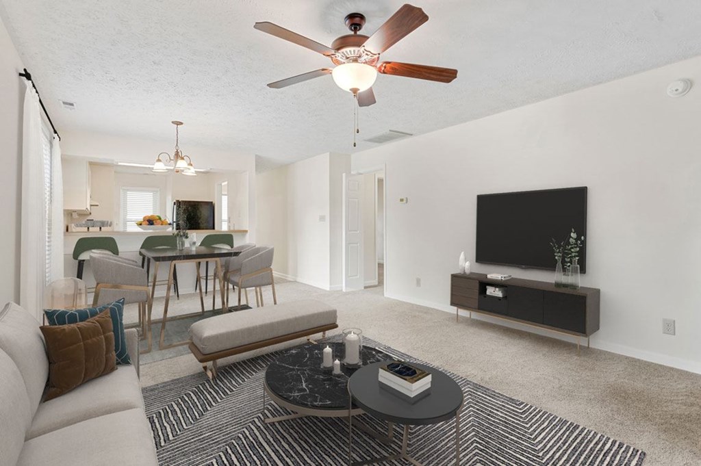a living room with a couch and a ceiling fan