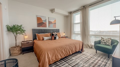 a bedroom with a bed and a chair and a window at Makers Rise, Virginia, 20171