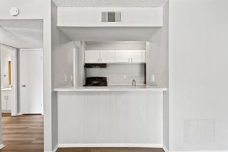 a kitchen with white cabinetry and white walls  at Lakes Edge Apartments, North Carolina, 27409