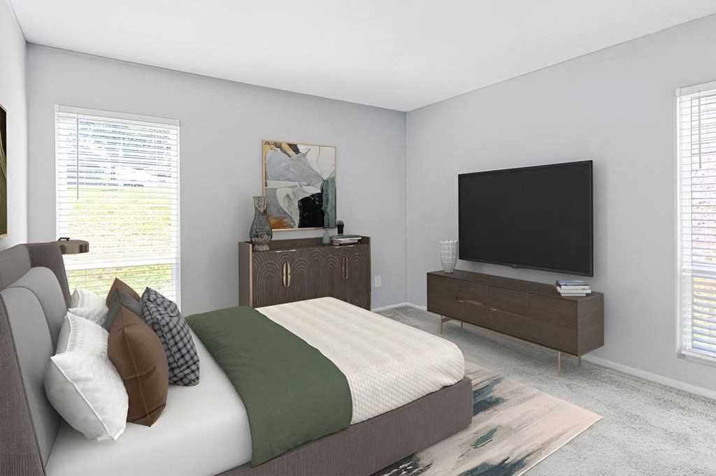 Bedroom with a bed and a television at Lakes Edge Apartments, Greensboro, North Carolina