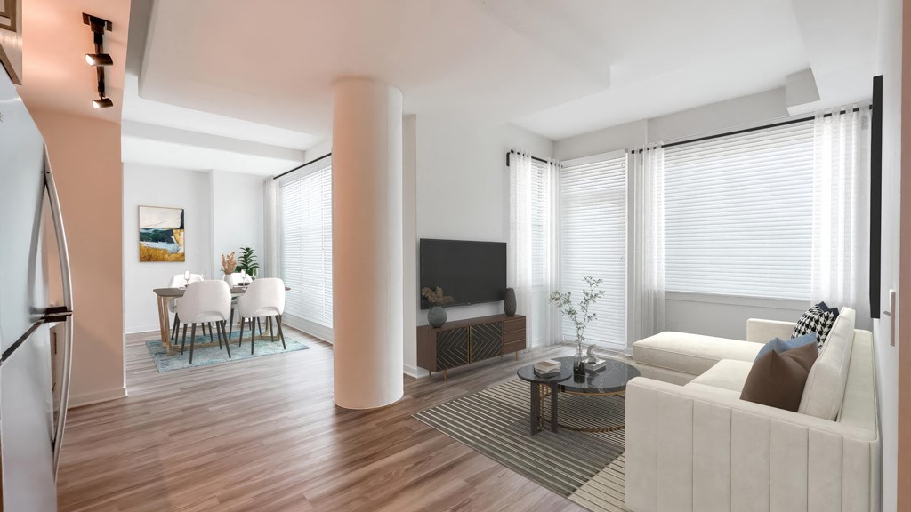 A modern living room with a white sofa and a television.at Makers Rise, Virginia, 20171