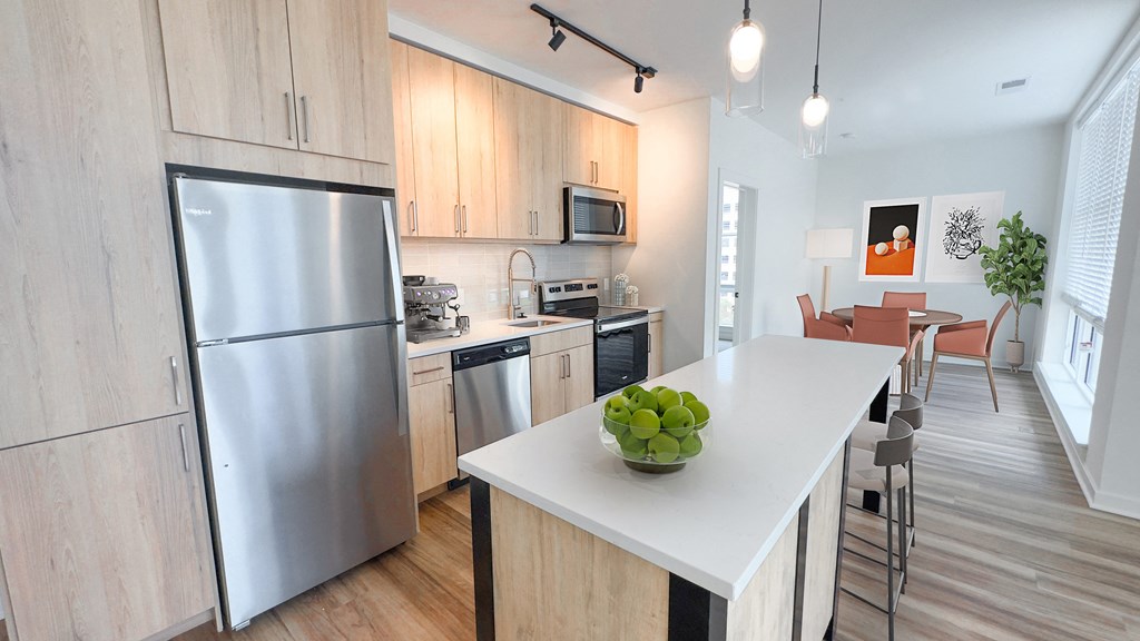 a kitchen with stainless steel appliances and a white counter top at Makers Rise, Herndon Virginia