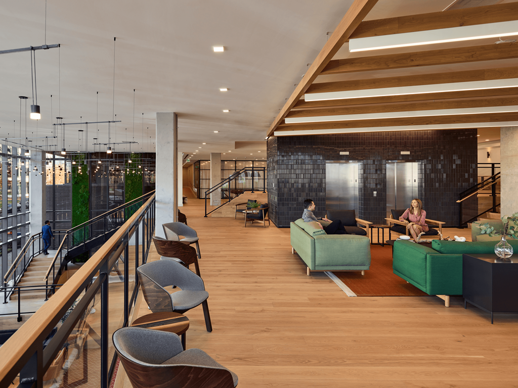 a large lobby with couches and chairs and a staircase at Makers Rise, Herndon, 20171