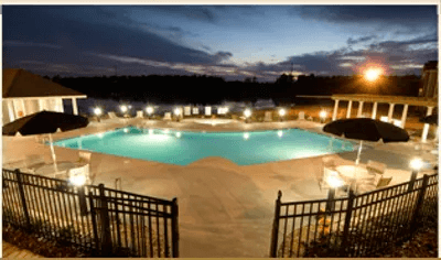 Night view of the Swimming Pool and Sundeck at Village on the Lake Apartments, Spring Lake, 28390