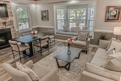 A living room with a fireplace and a dining table.