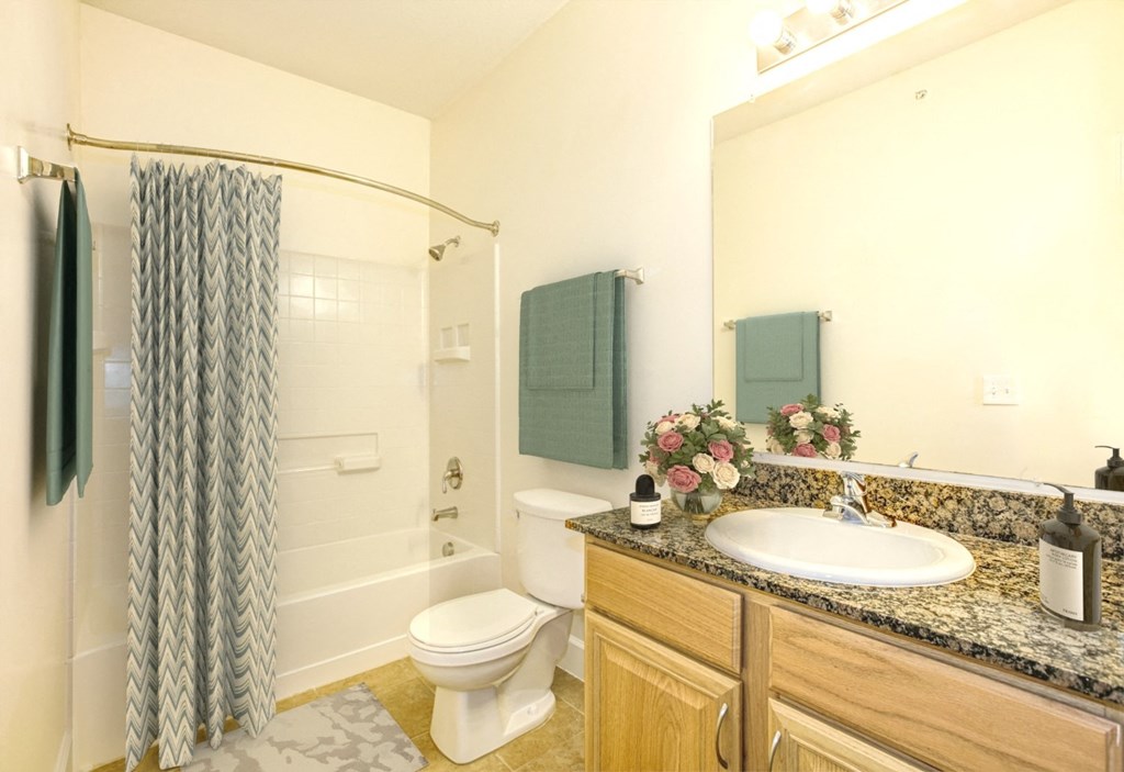 a bathroom with a sink toilet and a shower at Stone Gate Apartments, Spring Lake, NC