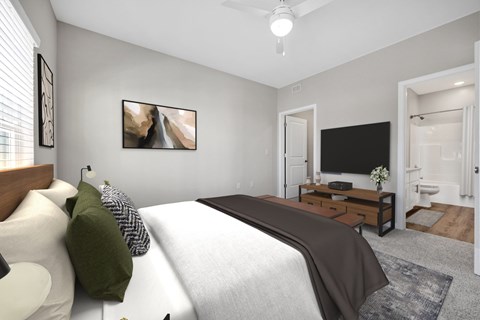 A bedroom with a large bed and a flat screen TV.