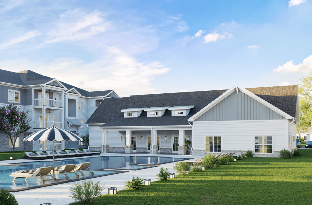 A white house with a pool in front of it.at The Landings at Hard Scrabble, Columbia, 29203