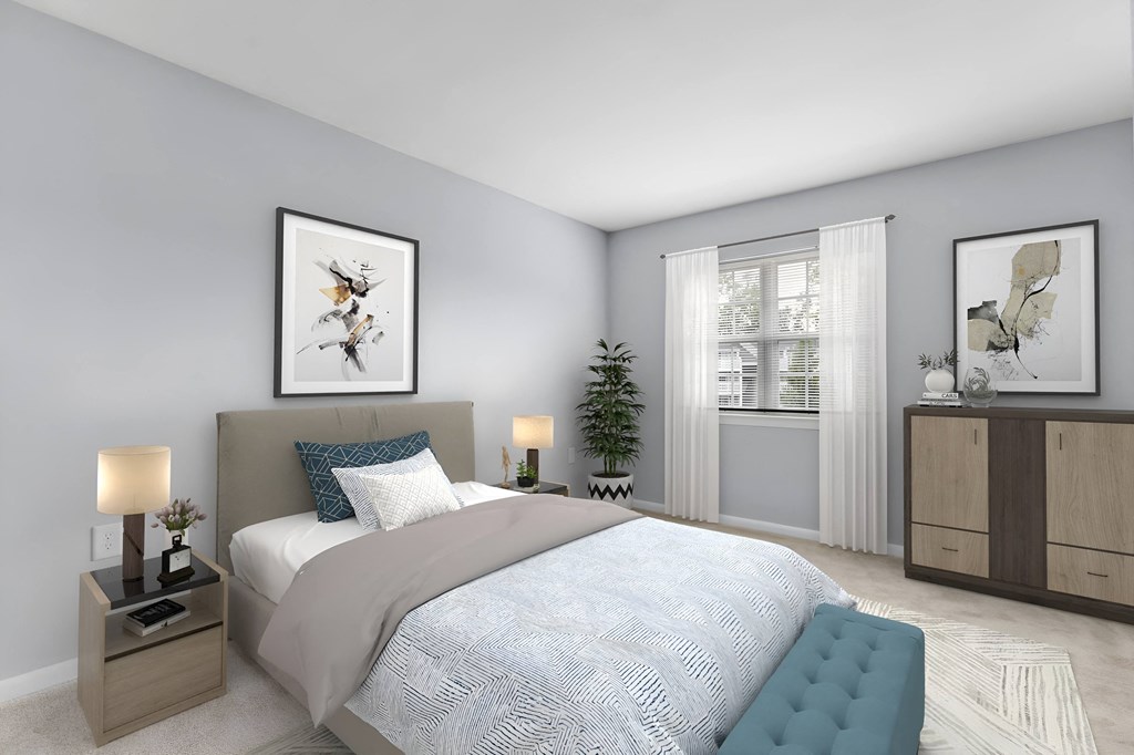 a bedroom with grey walls and a white bed at West Pointe Apartments in Burlington, NC
