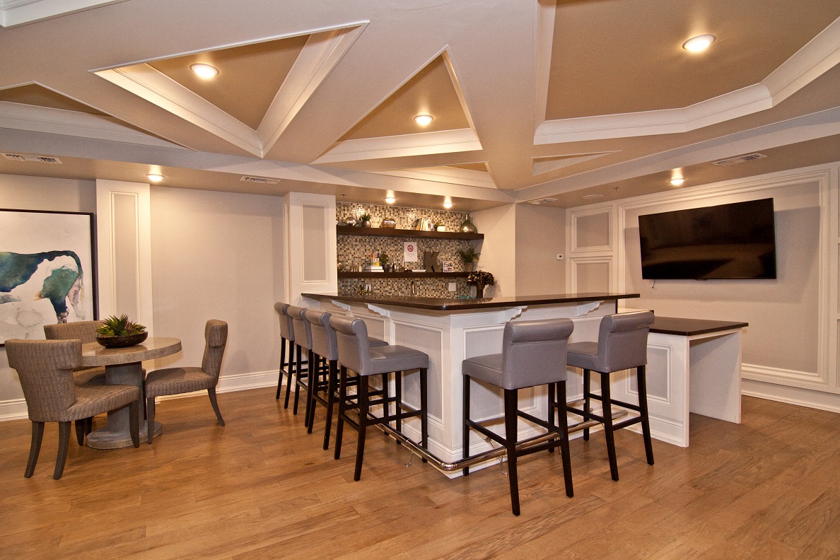 a living room with a bar and a television