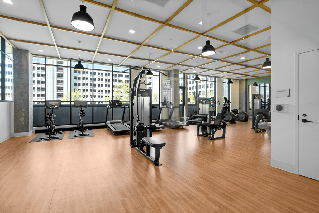 A gym with a variety of equipment and a view of a city skyline at Makers Rise, Herndon, VA