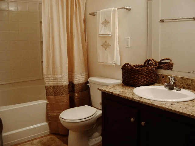 One bedroom apartment bathroom at Village on the Lake Apartments, Spring Lake, NC