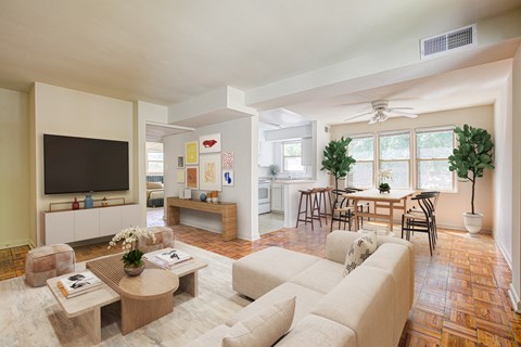 A living room with a white couch and a wooden coffee table.