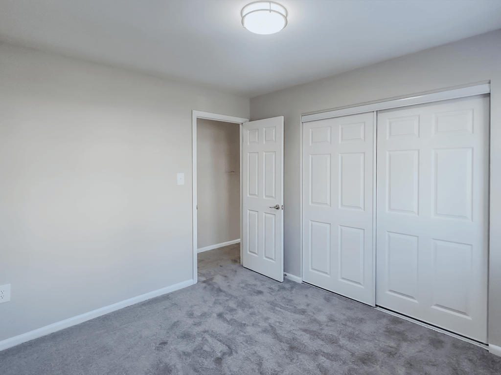 an empty bedroom with two closets and a door to a hallway at Middletown Valley, MD, 21769