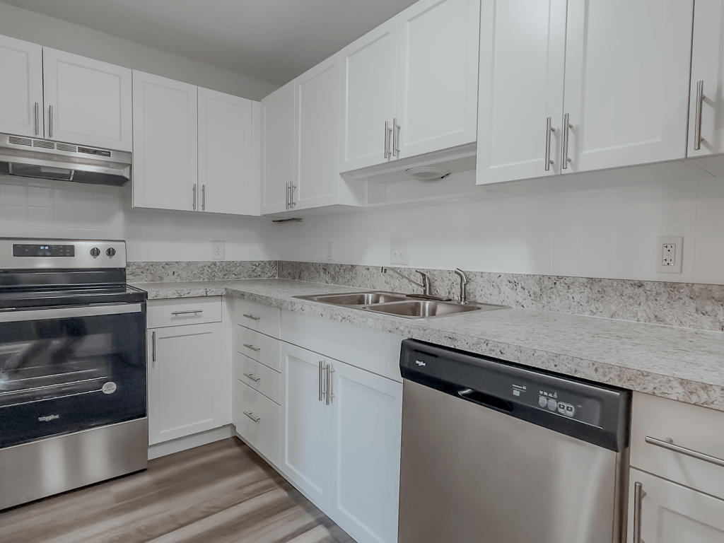 an empty kitchen with white cabinets and stainless steel appliances at Middletown Valley