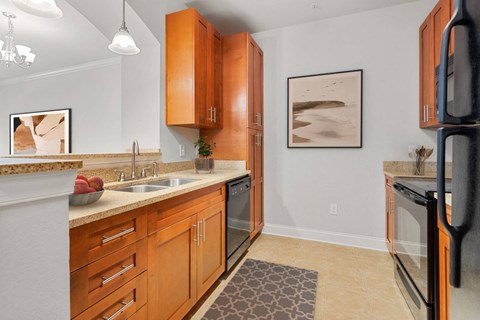 a kitchen with wooden cabinets and a sink and a refrigerator