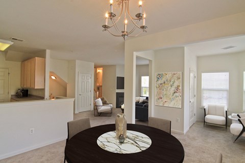 A dining room with a round table and chairs.