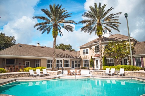 A large house with a pool in front of it.