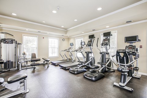 A spacious home gym with a variety of exercise equipment.