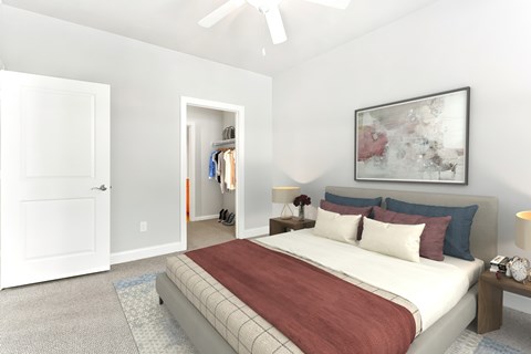 A bedroom with a large bed and a painting on the wall.