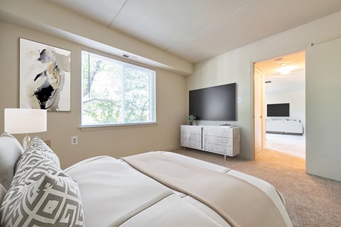 A bedroom with a large bed and a television.