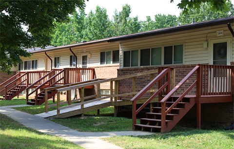 an exterior view of an apartment building with stairs