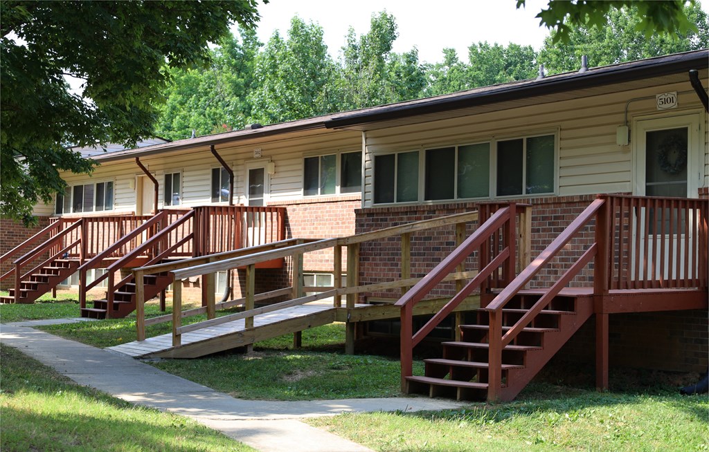 an exterior view of an apartment building with stairs