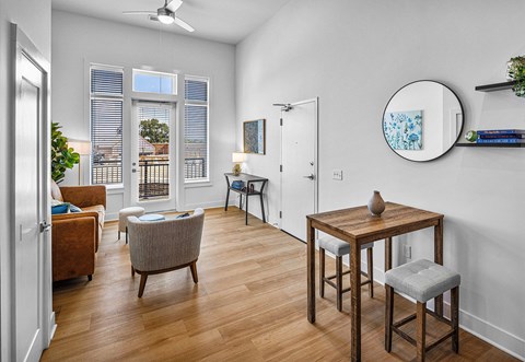 A living room with a brown chair and a wooden table.