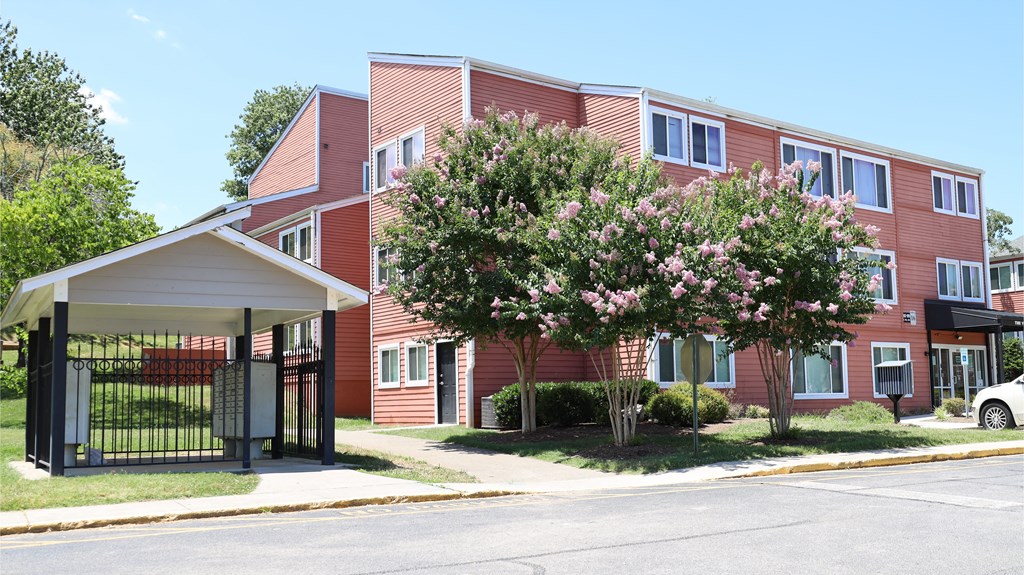 a red apartment building with a gated entrance