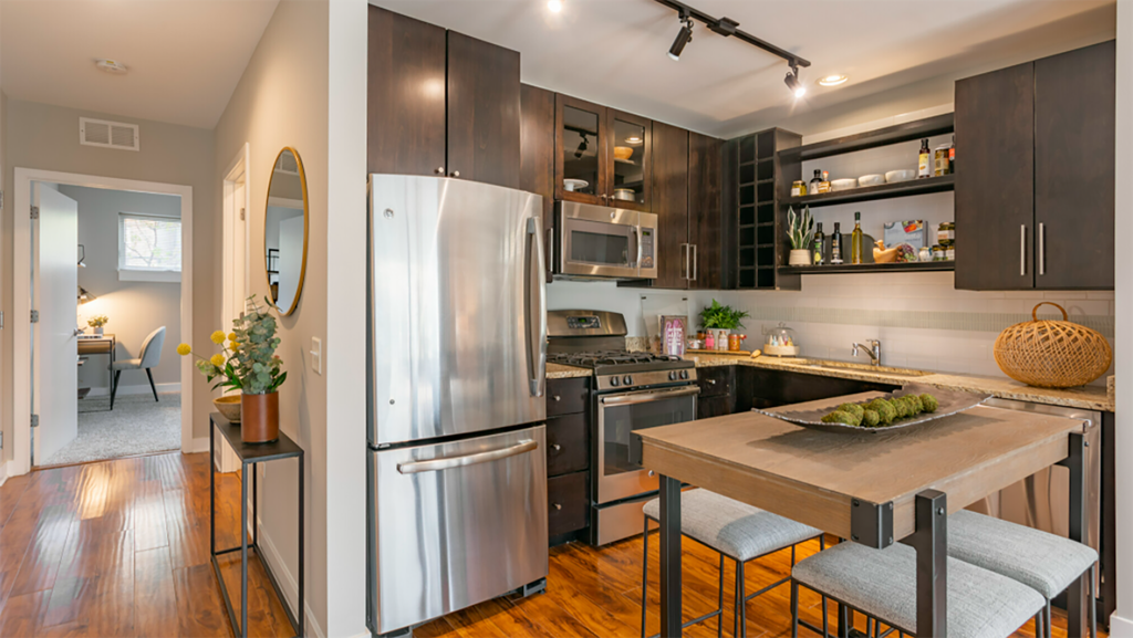 a kitchen with stainless steel appliances and a wooden table