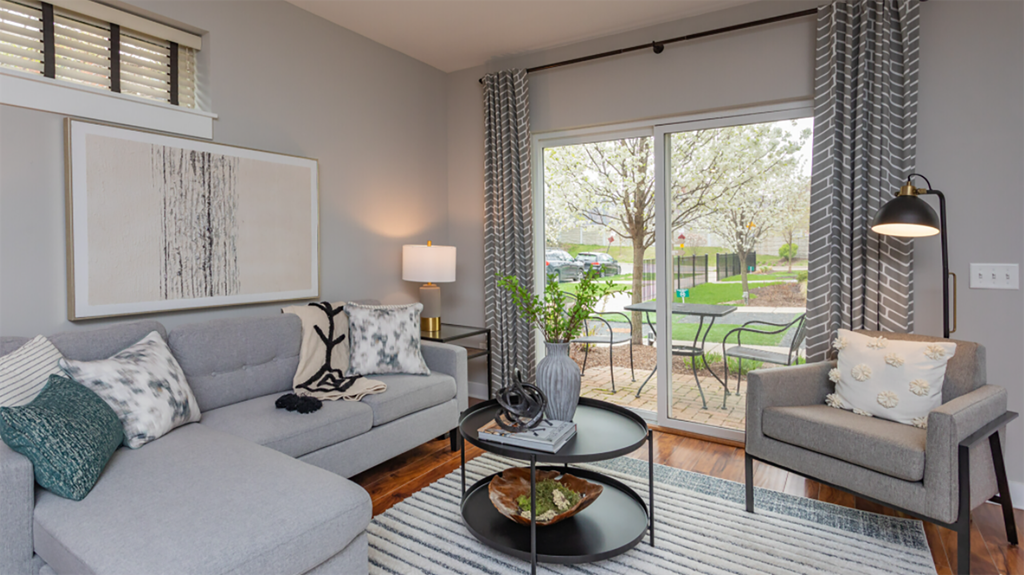 a living room with couches and chairs and a sliding glass door