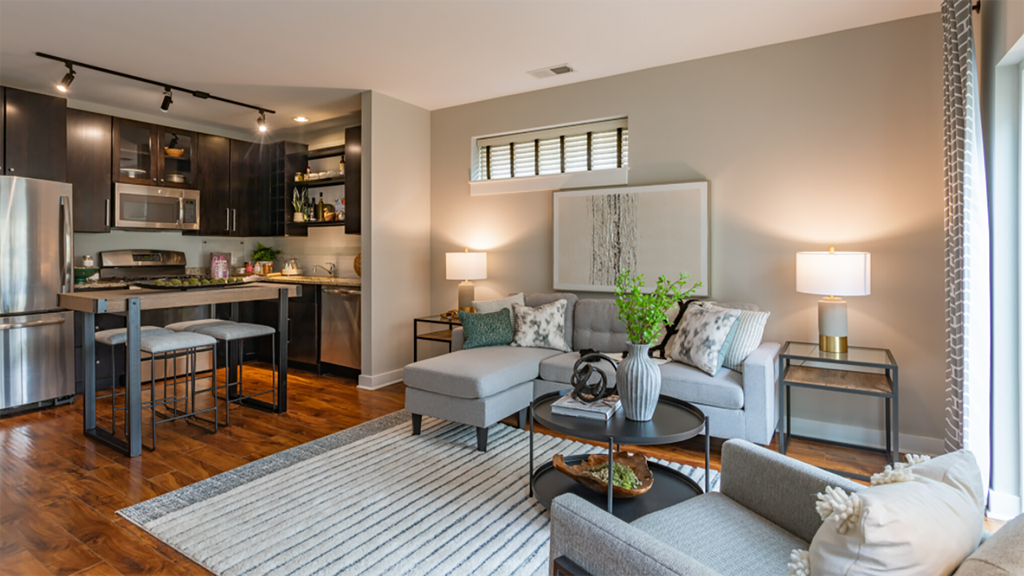 a living room and kitchen with a couch and a table