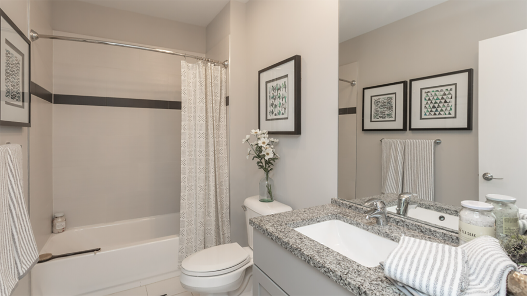 a bathroom with a sink and a toilet and a shower