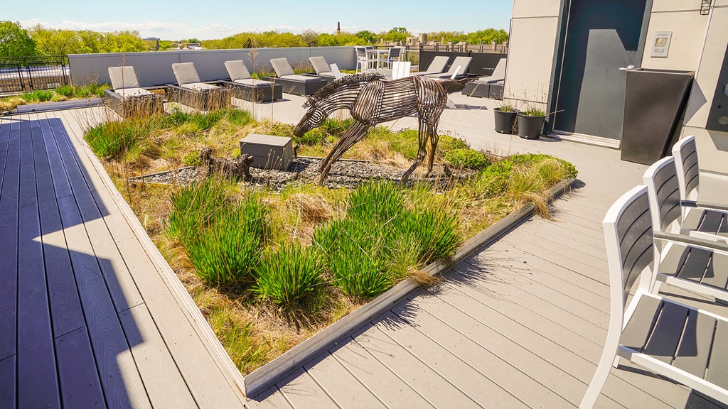 a sculpture of a zebra in a garden on the roof of a building