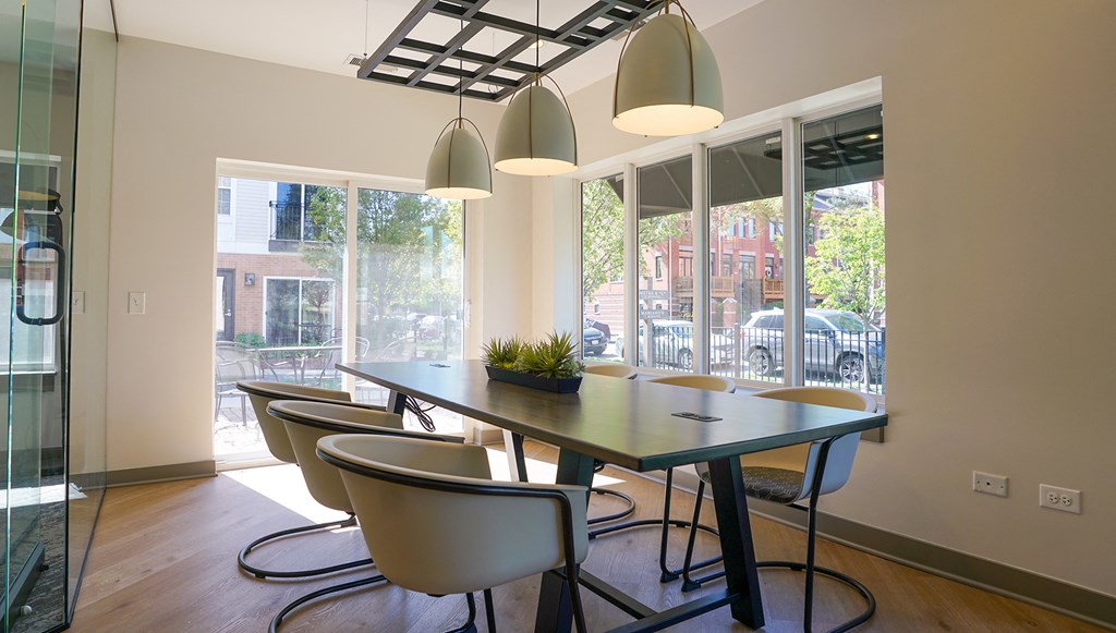 a dining room with a table and chairs and a large window