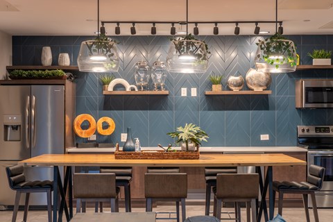 A modern kitchen with a wooden table and chairs.