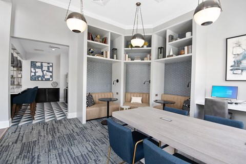 A modern office space with a long table and chairs.