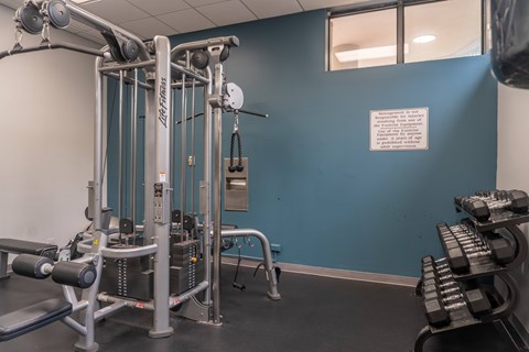 A gym with a blue wall and a sign that says "No Smoking".