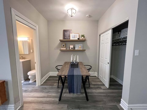 A dining room with a table and chairs.